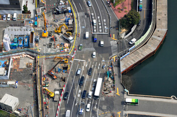 Aerial view of road construction work with excavators at Tokyo and typical road surface marks written in Japanese showing destination of the path, exit names of expressways