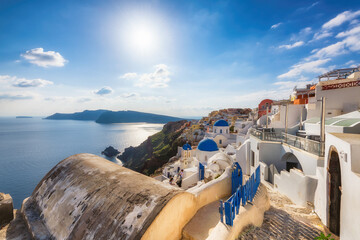 Spectacular view of Greek orthodox church with blue domes and sea in  Santorini island, Greece.
