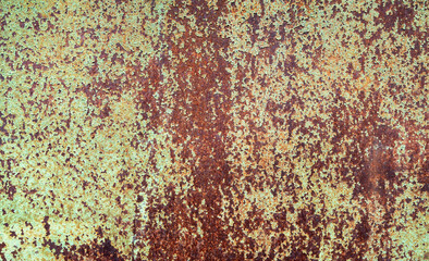 Flakes of old paint on rusty metal