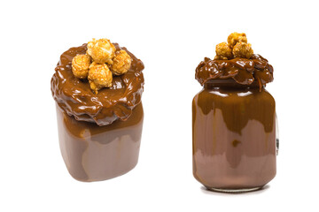 Chocolate milkshake with whipped cream, cookies, waffles, served in glass mason jar. 