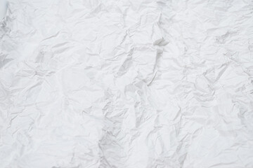 Crumpled white paper background.