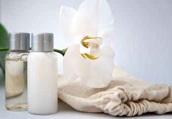 Set of cosmetics for skin care face, white Orchid and eco bag on a grey-blue background.Organic cosmetic. Beauty concept.