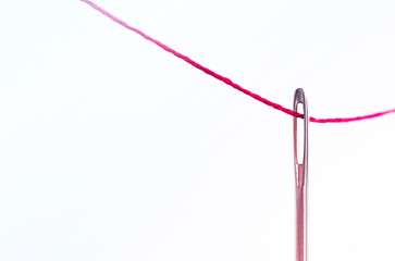 sewing needle with red thread