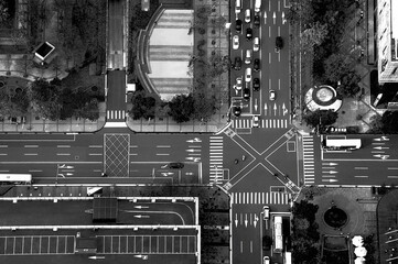 Black and white aerial view of busy intersection of roads in Taipei with traffic, typical road...