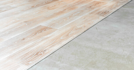 replacement of old cracked floor at new wood laminate maintenance concept