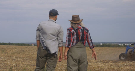 Farmers talking during plough in field