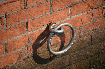 iron ring anchored to the red brick pier for mooring boats