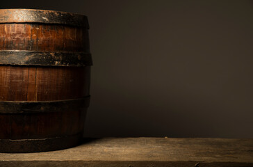 Beer. Still life with Vintage beer barrel and glass light beer. Fresh amber beer concept. Green hop and gold barley on wooden table. Ingredients for brewery. Brewing traditions