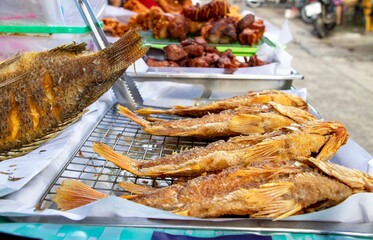 fried fish on a tray in a market