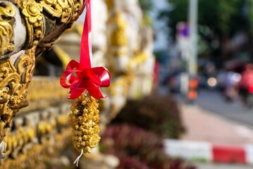 old jasmine garland hanging on a statue