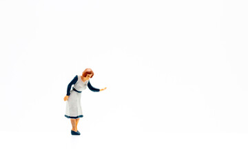 Miniature people standing on white background and copy space for your text 