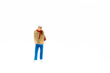 Miniature people standing on white background and copy space for your text 