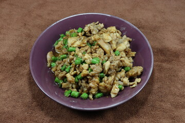 Traditional fried and stirred minced pork with cutting green bean and seasoning with soy sauce and pepper on the plate. Famous local street food in Thailand.
