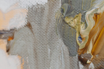selective focus: Fresh colored oil paints on a woven canvas are abstractly mixed and closely...