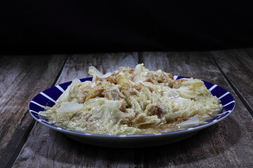 Traditional fried and stirred Chinese cabbage with tofu seasoning with soy sauce and pepper. Famous vegetarian menu in Asia restaurant. 