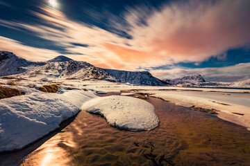 Night on Utakleiv beach, Norway, Europe. Fool moon light illuminatied winter hills on Lofoten Islands archipelago. Life over polar circle. Beauty of nature concept background.