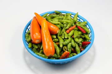 Pile of fresh and organic chilly on the plastic basket. Famous hot and spicy ingredients in Asia restaurant. 