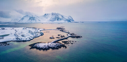 Fototapeta na wymiar View from flying drone of small fishing village - Hovsund, Norway, Europe. Amazing winter scene of Lofoten Islands. Fantastic morning seascape of Norwegian sea. Life over polar circle..