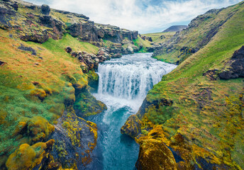 Breathtaking morning scene of waterfall on Skoga river. Aerial summer view from the tourist trek from famous Skogafoss waterfall to the top of the river, Iceland, Europe.