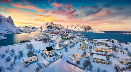 View from flying drone of Reine village, Moskenesoya island, Norway, Europe. Aerial evening scene of Lofoten Islands. Fantastic winter sunset on Norwegian sea. Life over polar circle..