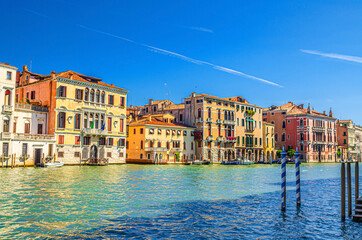 Fototapeta na wymiar Grand Canal waterway with row of colorful multicolored palace buildings in Cannaregio sestiere Venice historical city centre, blue clear sky background, beautiful summer day, Veneto Region, Italy