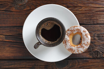Cup of coffee and glazed bagel