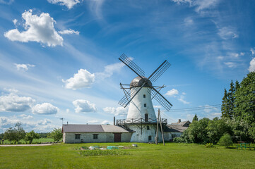 Fototapeta premium Landscape with an old windmill. Amazing summer view of Puraviku windmill, Estonia.