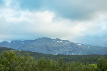 Mountain ridge against cloudy sky.  Nature of Norway