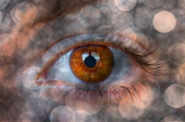 Beautiful girl's colorful eye with mystical bokeh effect 