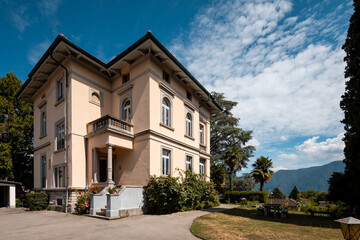 Ancient villa surrounded by nature in the hills in Switzerland. Sunny summer day