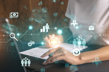 Businesswoman typing on computer in office. Financial and research icon hologram. Double exposure.