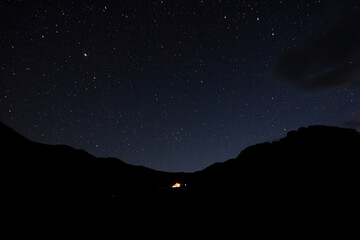 Starry sky in the mountains. Tourist tent in the mountains under the starry sky. © Anna