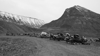 Snowmobiles in Longyearbyen on the island Spitsbergen waiting for the winter and the snow. Black and White picture on Svalbard.