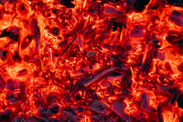 Smoldering charcoal in a bonfire, background texture