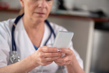 Female doctor using her mobile phone