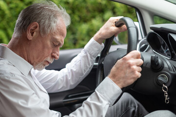 Tired man falling asleep in car