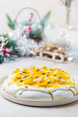 Meringue cake Pavlova with fresh mango and passion fruit and whipped cream on slate, stone or concrete background