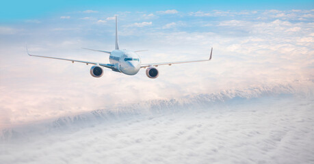 Fototapeta na wymiar White passenger airplane in the clouds - Travel by air transport