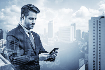 Prosperous European businessman in suit texting phone the details of corporate meeting. Bangkok cityscape. The concept of business communication. Downtown. Double exposure.