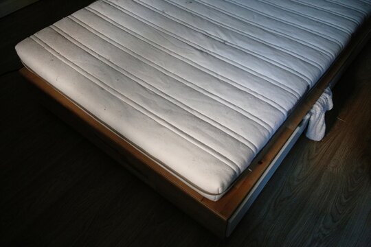 Dirty bed mattress in the bedroom of abandoned house