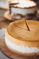 Piece of pumpkin homemade cake. Festive dessert concept. pumpkin tart on cozy cafe background, selective focus, noise effect