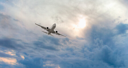 Commerical airplane flying under the storm clouds