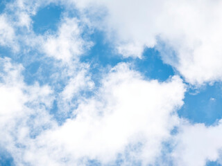 White clouds on a blue sky background.
