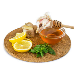 home treatment kit for flu and seasonal colds. Lemon, mint, honey, ginger and garlic on wooden tray isolated on white background