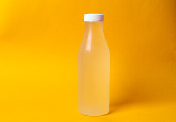 bottle with juice on a yellow background