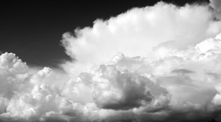 White clouds in the sky, black and white photo.