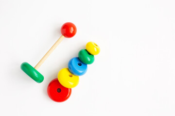 Pyramid from colored wooden rings on a white background.