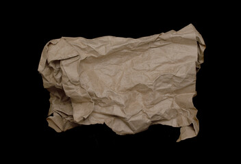Crumpled cardboard bag on a black background.