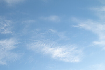 Cirrus clouds, (Ci), individual, white, fibrous, very thin and transparent. Cloud on a background of blue sky.