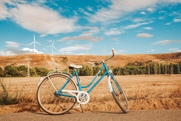 Fototapeta na wymiar vintage blue bicycle parked in the rural countryside in a summer day